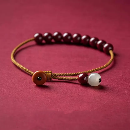 Hand-woven cinnabar bracelet with Hetian jade accents and simple geometric design