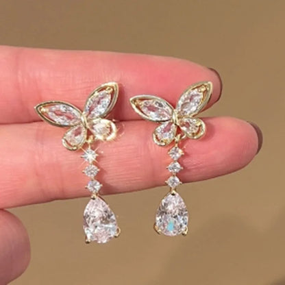Pair of bow-shaped stud earrings with platinum electroplated finish on zinc alloy