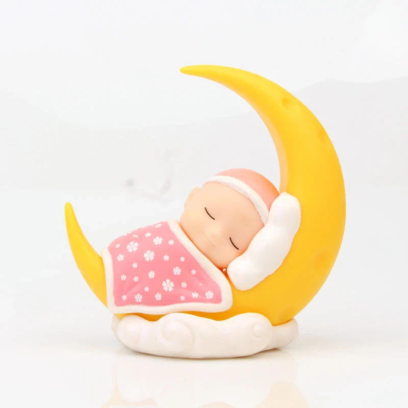 Adorable moon-themed cake decorations and party supplies for baby birthday celebrations