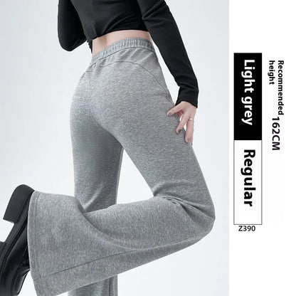 Women's high waist bootcut sports pants in black cotton with fleece lining and micro elasticity, slightly flared leg.