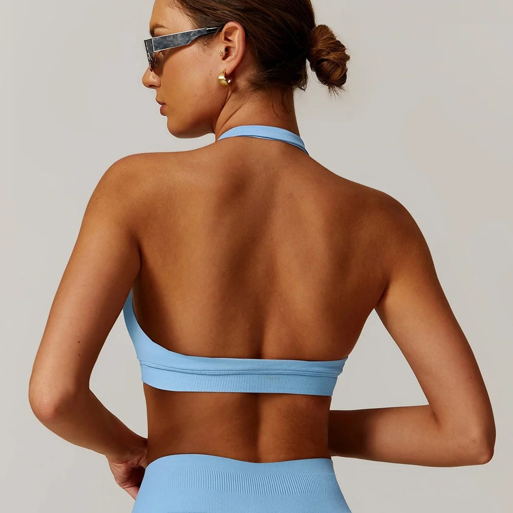 Women's halter yoga bra with hollow design in plum purple colour showing medium support construction
