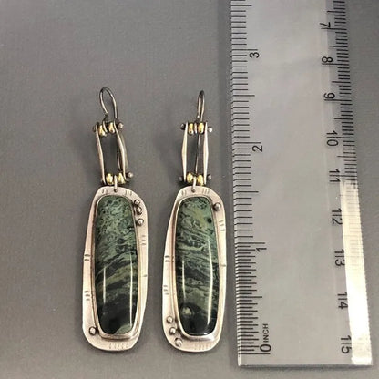 Two-tone geometric marble pattern alloy earrings with butterfly clasp, showing front and side views