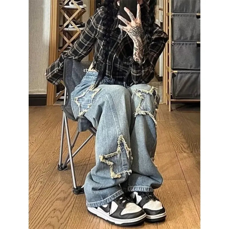 Blue high-waisted wide-leg denim trousers with a straight-leg cut on a model.