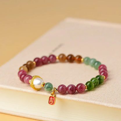 Chalcedony and tourmaline geometric bracelet with 6.5mm beads on a wrist.