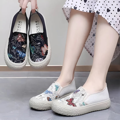 Women's black and white slip-on canvas shoes with round toe and decorative stitching