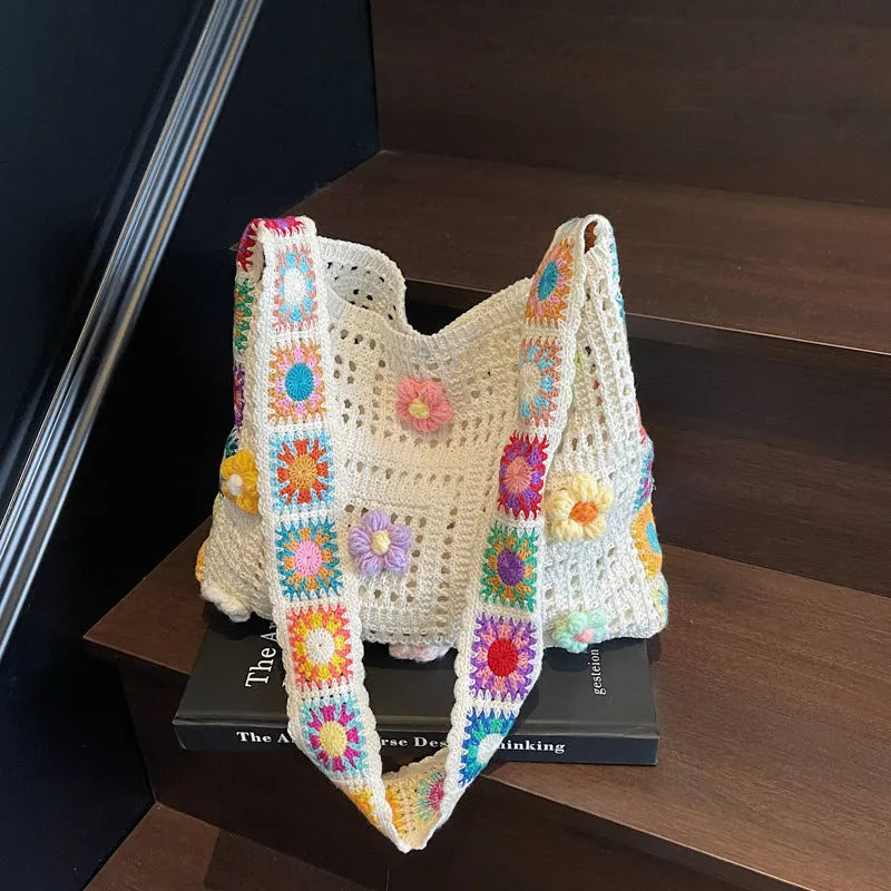 Women's large white knitted shoulder bag with hollow weave pattern and single strap.
