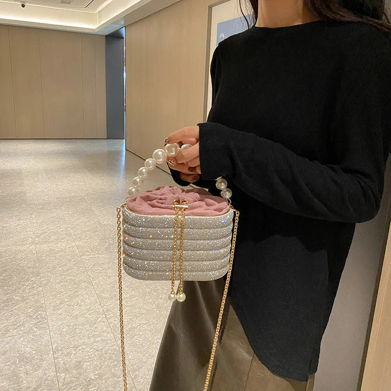 Women's one-shoulder crossbody bag with pearl beading, round shape, and internal zipper pocket in black colour