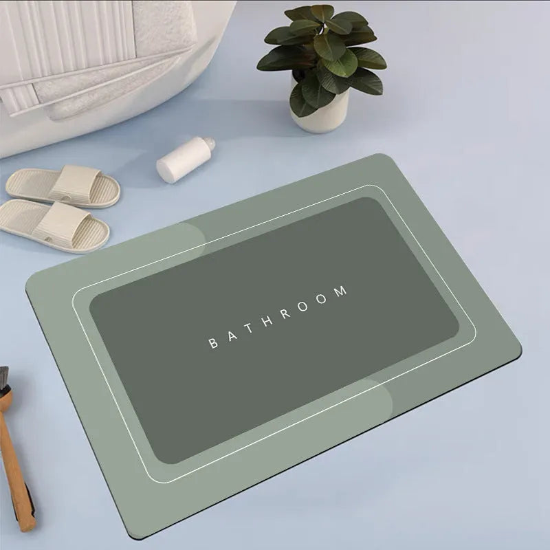 Oval diatomite bathroom floor mat in blue with natural rubber non-slip backing on tiled floor.
