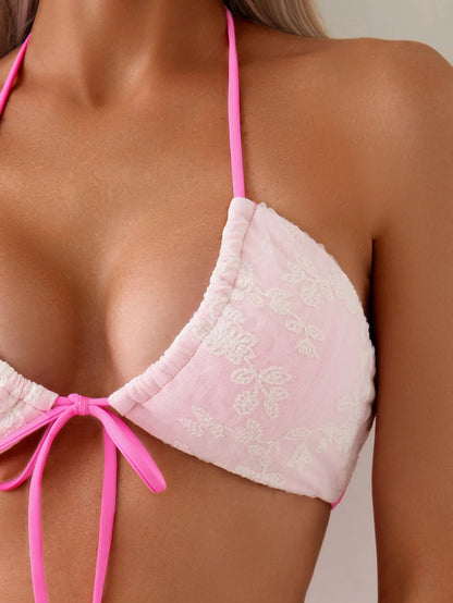 Pink lace crochet halter neck swimsuit top and matching briefs on a mannequin