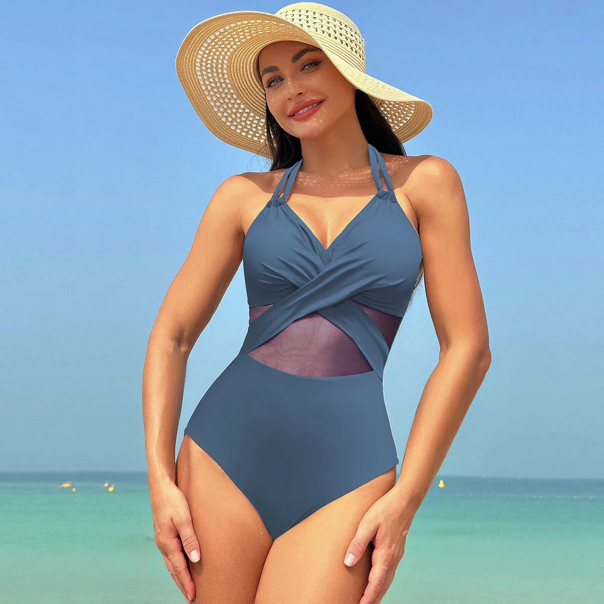 One-piece swimsuit with halter-neck and cross-strap design, available in various solid colors and a leopard print pattern