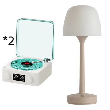 Retro-style turntable Bluetooth speaker with glowing RGB light projection on a wooden surface.