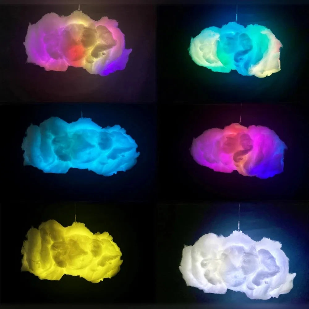 White fabric cloud shaped light hanging from ceiling with multi-coloured LED glow.