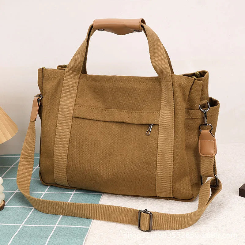 Large canvas tote bag in horizontal square shape with open-zip sides and internal organisers