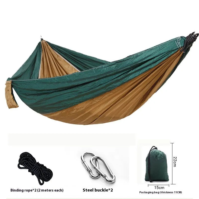 Parachute cloth double camping hammock in chosen colour, with black buckles and round ropes on a tree.