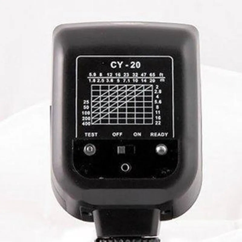 Compact black hot shoe camera flash with its head tilted upwards, showing the flash bulb and hot shoe mount.