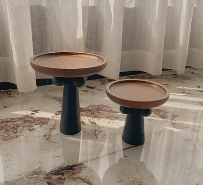 Round beech wood tray with high legs for candles and aromatherapy accessories on wooden table