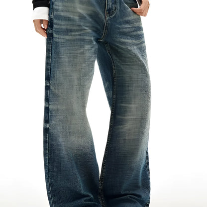 Men's wide leg mid waist jeans in dark blue denim with straight loose cut and distressed cat beard detail