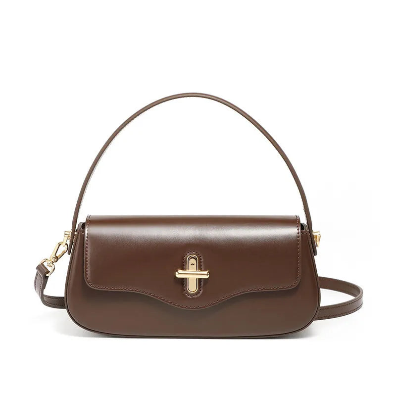 Genuine leather baguette handbag in horizontal square shape with clamshell opening and internal zip compartments