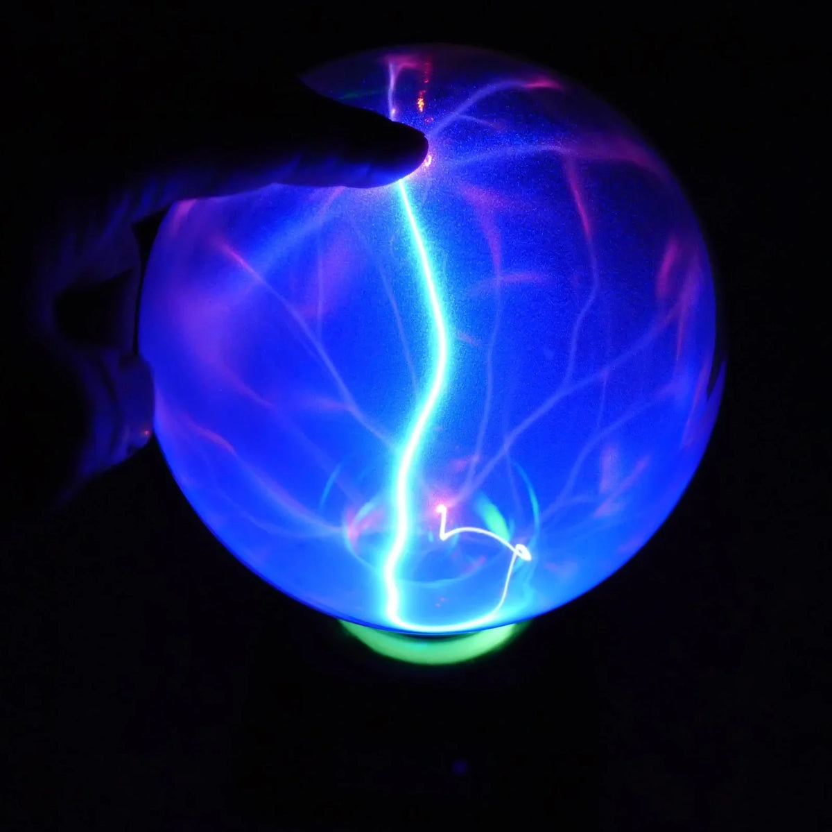 Plasma lightning ball with electrostatic induction showing colourful electrical discharges on glass surface