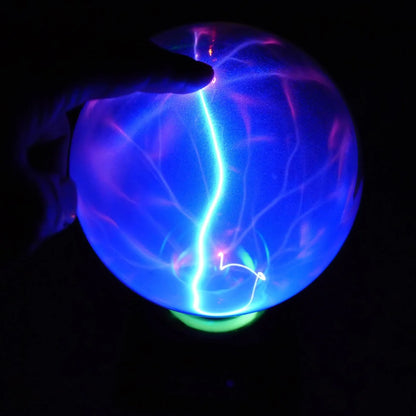 Plasma lightning ball with electrostatic induction showing colourful electrical discharges on glass surface
