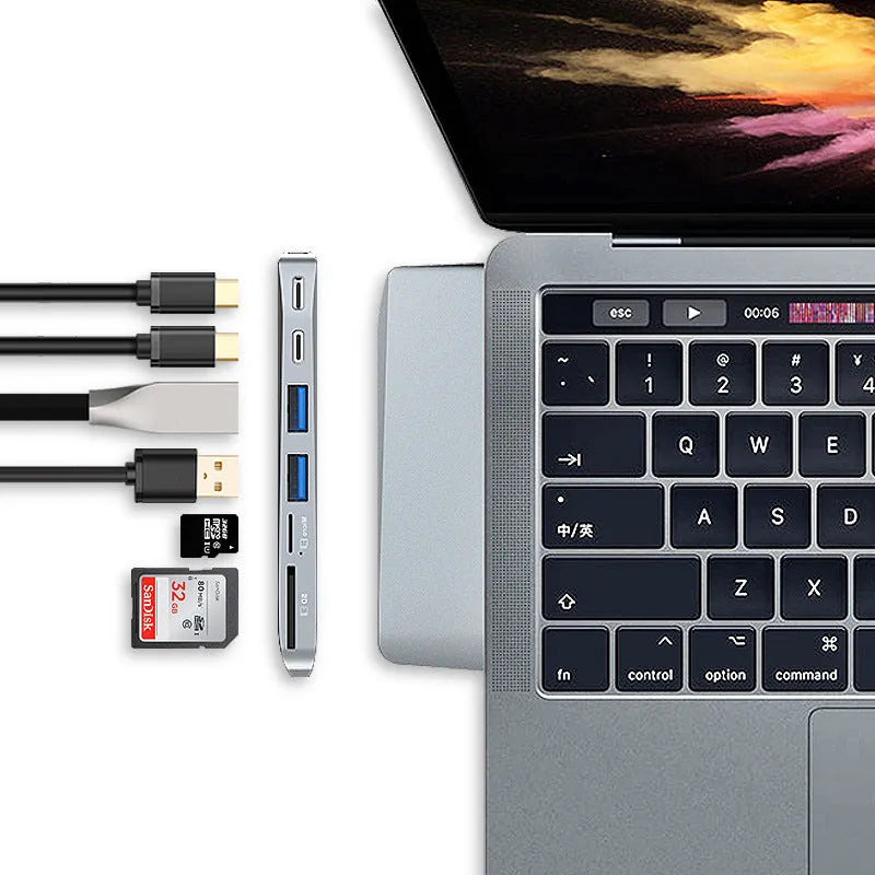 Silver 8-in-1 USB-C card reader hub for MacBook Pro with multiple ports including USB and SD slots.