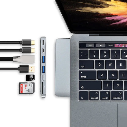 Silver 8-in-1 USB-C card reader hub for MacBook Pro with multiple ports including USB and SD slots.