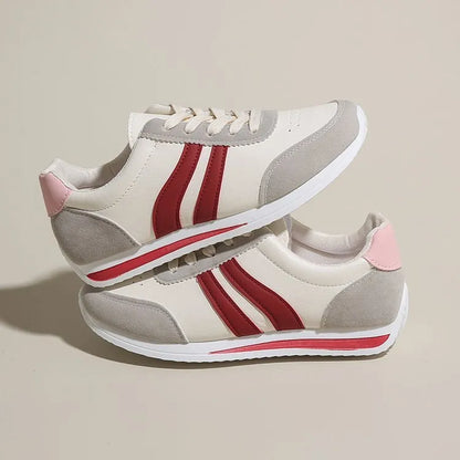Blue and red low-top lace-up sneaker with soft rubber soles and mesh lining