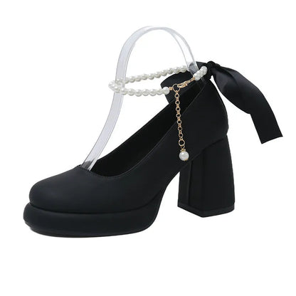 Women's beige preppy style Mary Jane shoes with chunky heel, ankle strap buckle, and pearl detail.