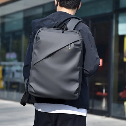 Large black waterproof PU leather laptop backpack with sewing thread details on a simple design.