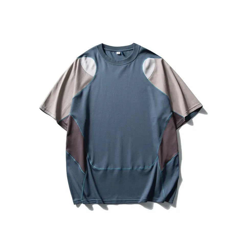 Man wearing a loose blue patchwork contrast colour short sleeve cotton blend sports t-shirt.