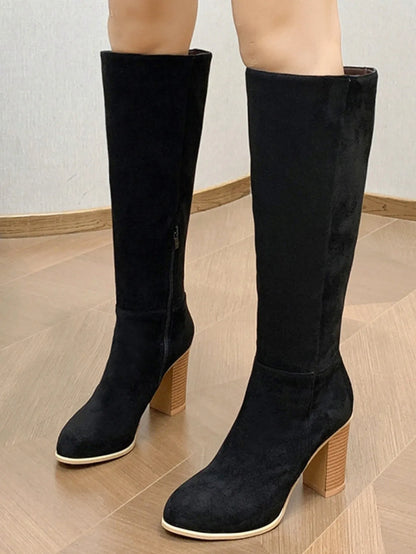 Black square toe high heel fashion boots for women on a neutral background