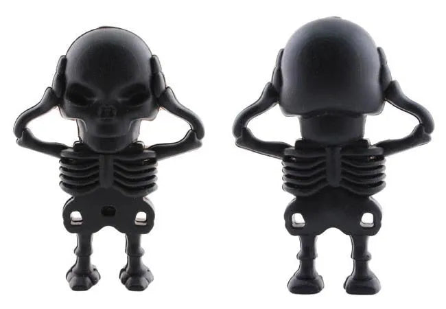 Skull-shaped black USB flash drive on a small metal keychain against a dark background.