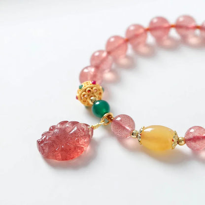 Women's strawberry quartz crystal beaded bracelet with Nine Tail Fox design on wrist
