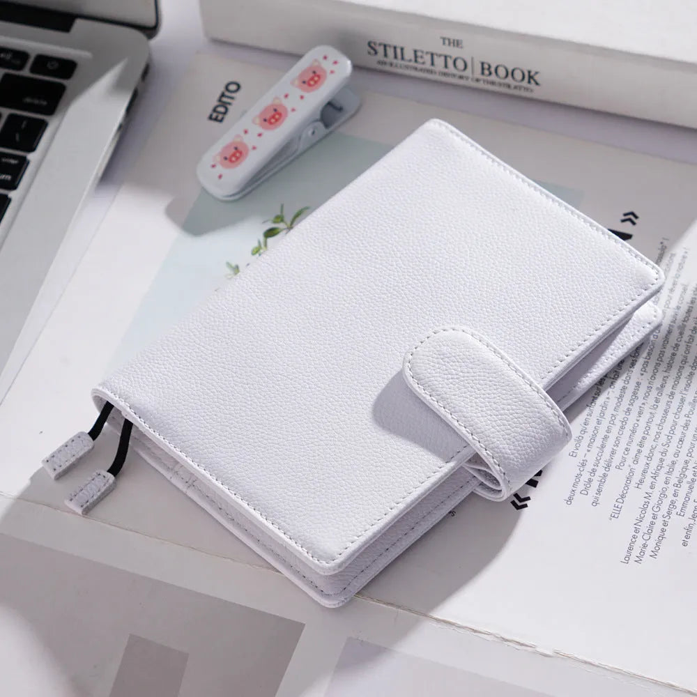 Close-up of a hand-embossed lychee pattern on an off-white A6 cowhide leather notebook with loose-leaf binding.