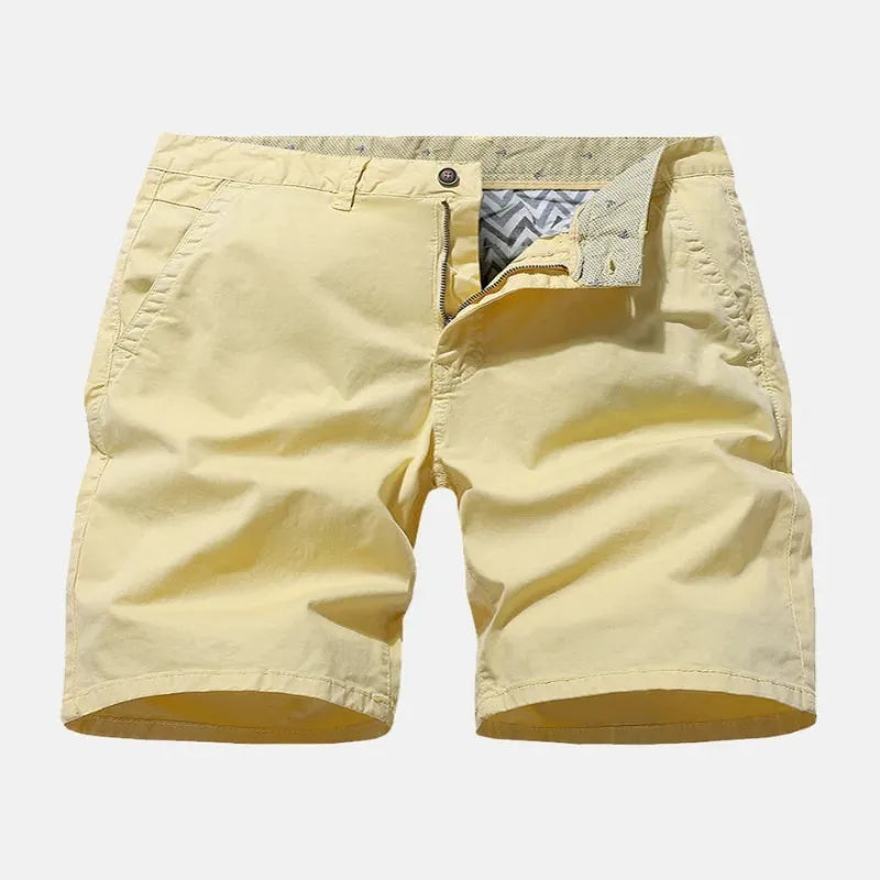 Man wearing blue denim loose-fit casual shorts with an elasticated waist, no belt.