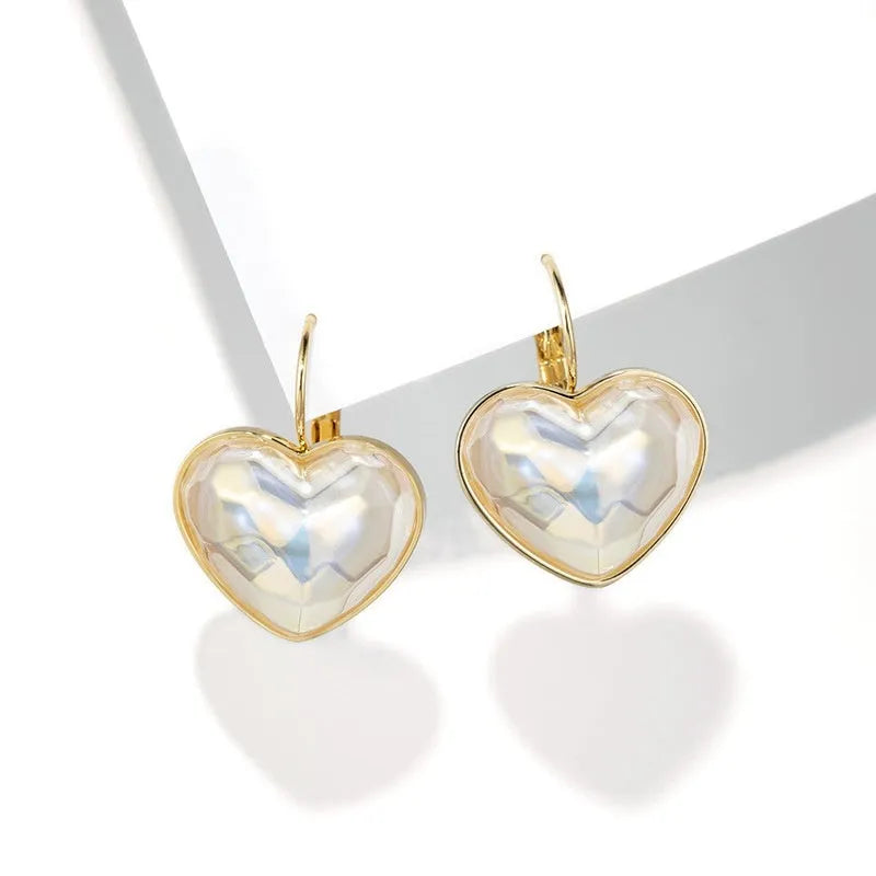 Gold-coloured alloy clip-on earring for women with a natural design.