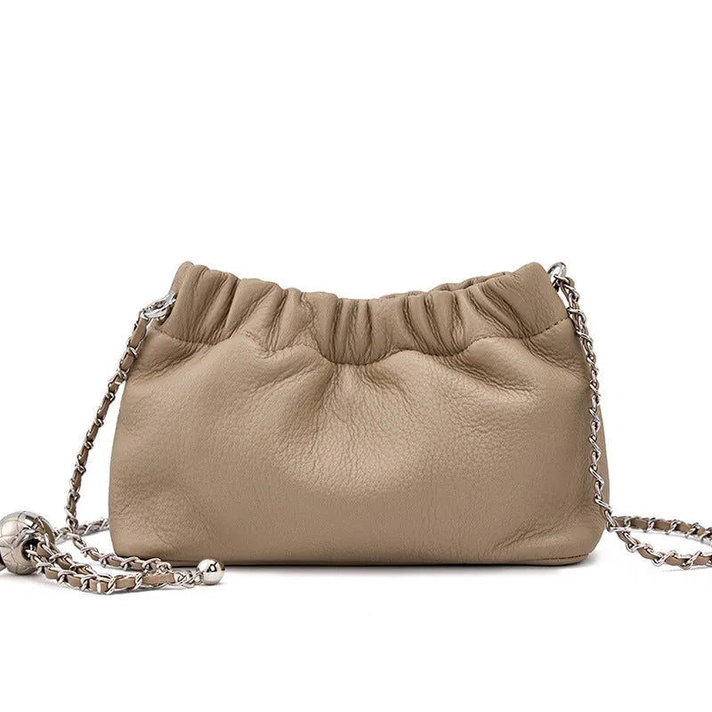 Women's dumpling-shaped genuine leather crossbody bag in three neutral colours showing slit pocket