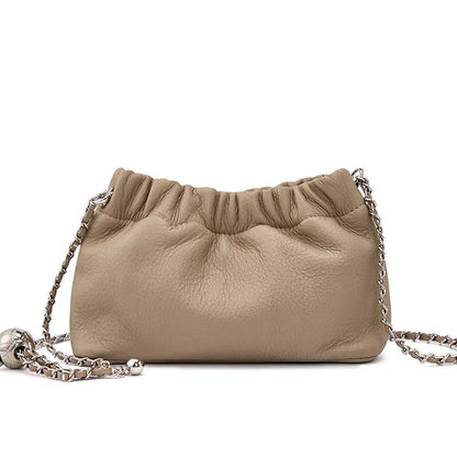 Women's dumpling-shaped genuine leather crossbody bag in three neutral colours showing slit pocket