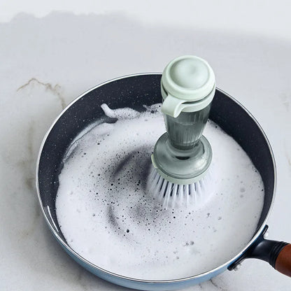 Milk white and mint green pot scrub brush with a soap dispenser handle and replaceable non-scratch bristles.