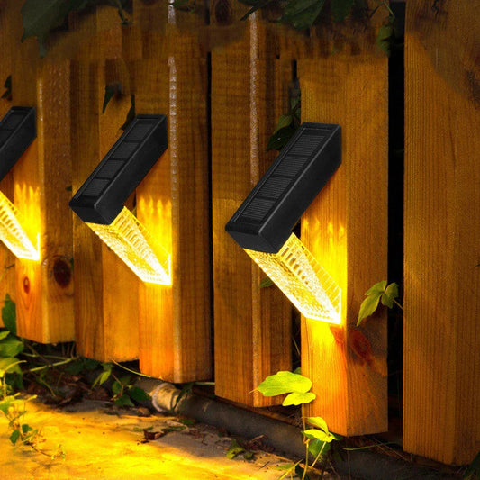 Waterproof solar-powered deck lights illuminating outdoor stairs, fence, and garden with warm, inviting glow