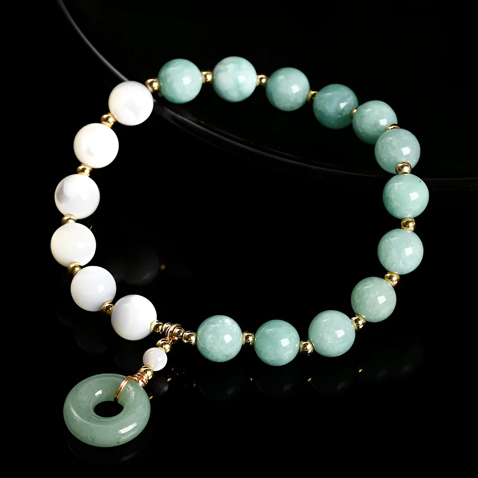 Blue Burma jade bead bracelet with copper horseshoe screw safety buckle on a wrist.