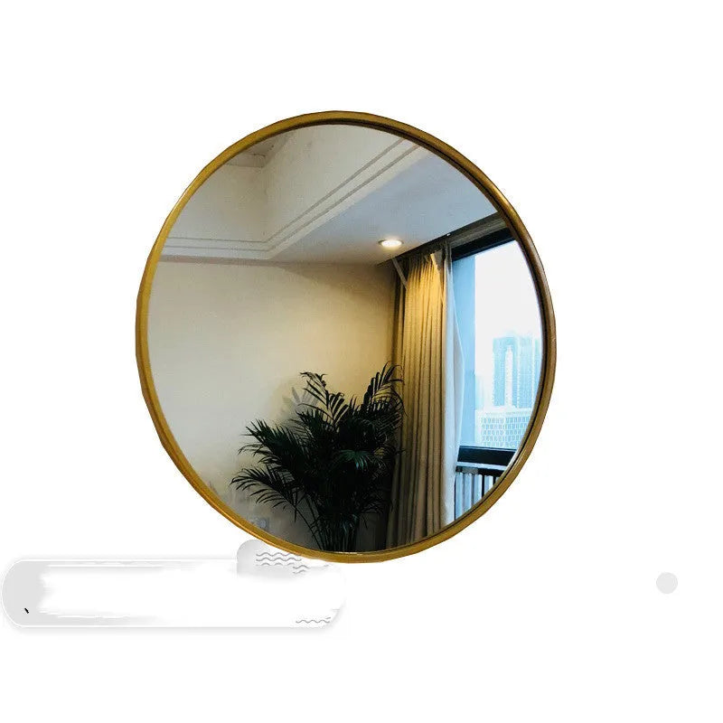 Round metal-framed wall mirror in black, white, or gold for bathroom.