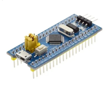 STM32F103C8T6 minimum system development board with blue PCB, Mini USB port, and pin headers.