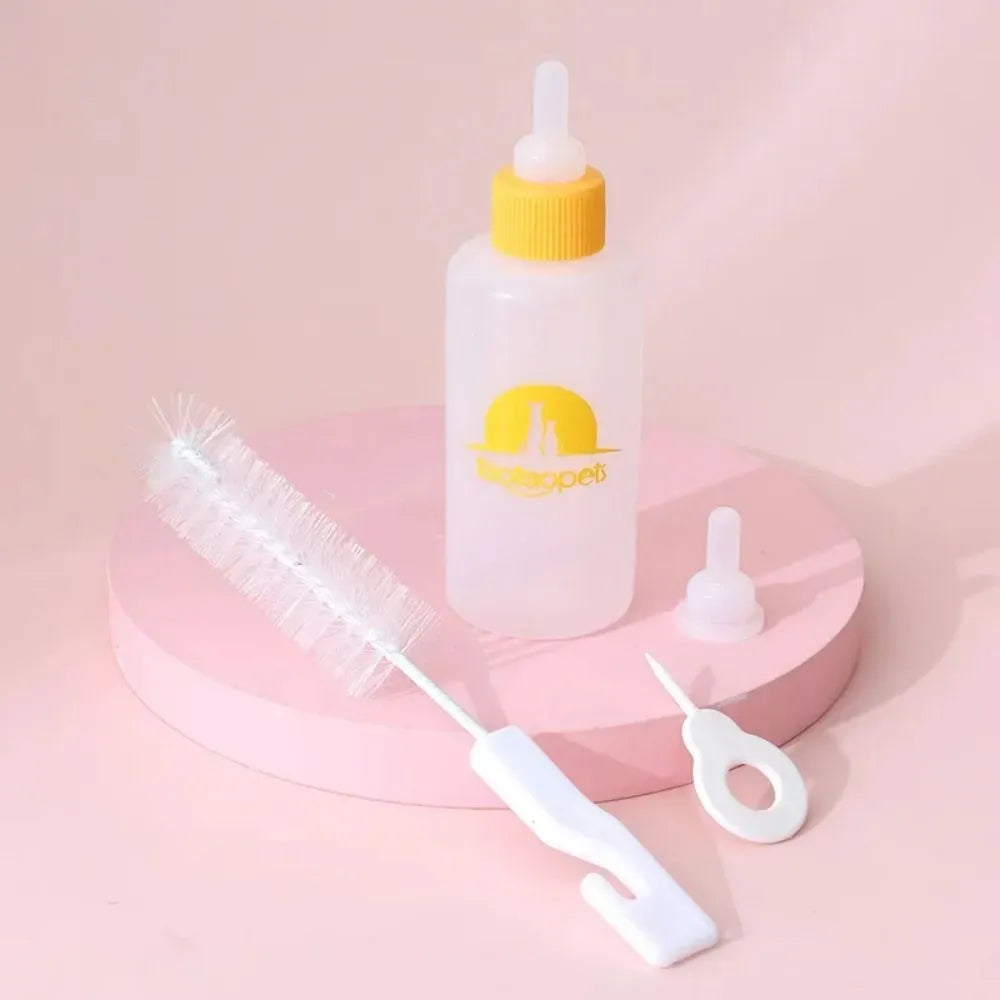Set of four coloured pet milk bottles with silicone teats and a cleaning brush for small animals.