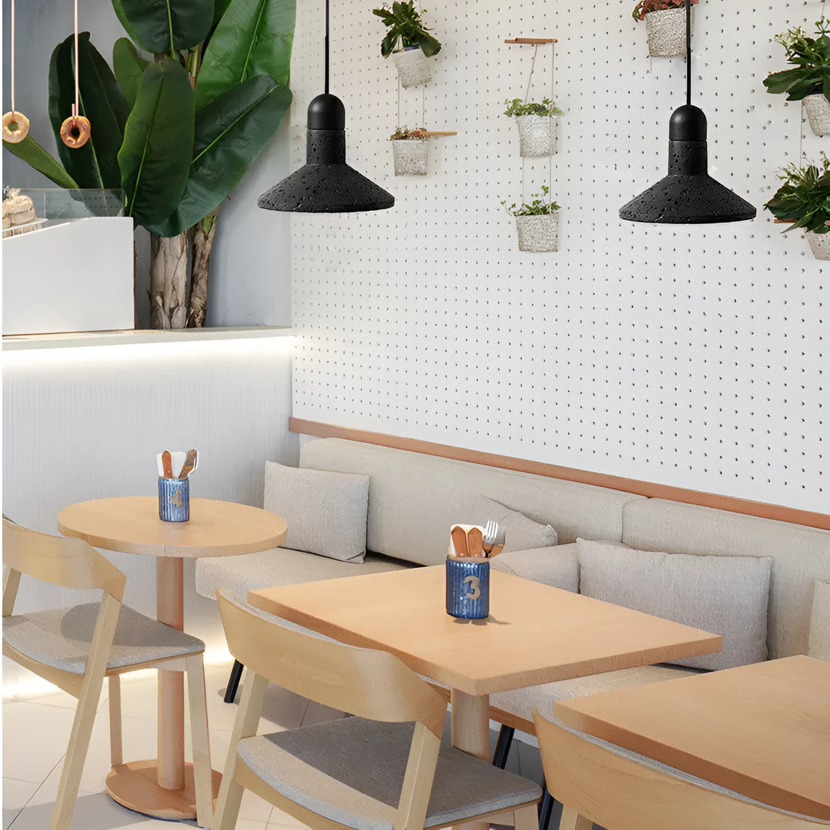Industrial style iron chandelier with an adjustable hanging cord above a dining table.