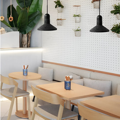 Industrial style iron chandelier with an adjustable hanging cord above a dining table.