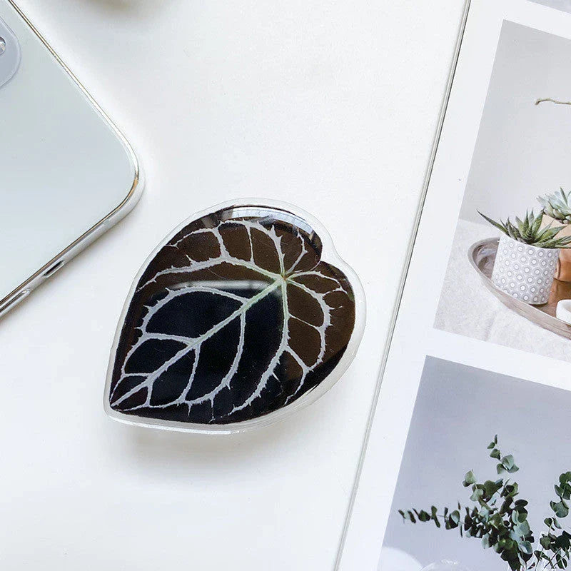 Stylish smartphone stand with leaf-inspired design for secure hands-free support and mobile device versatility