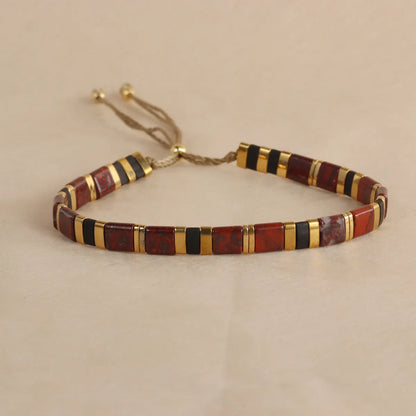 Geometric glass beaded pull bracelet in multiple colours including milky white, black, retro green, light blue, and red