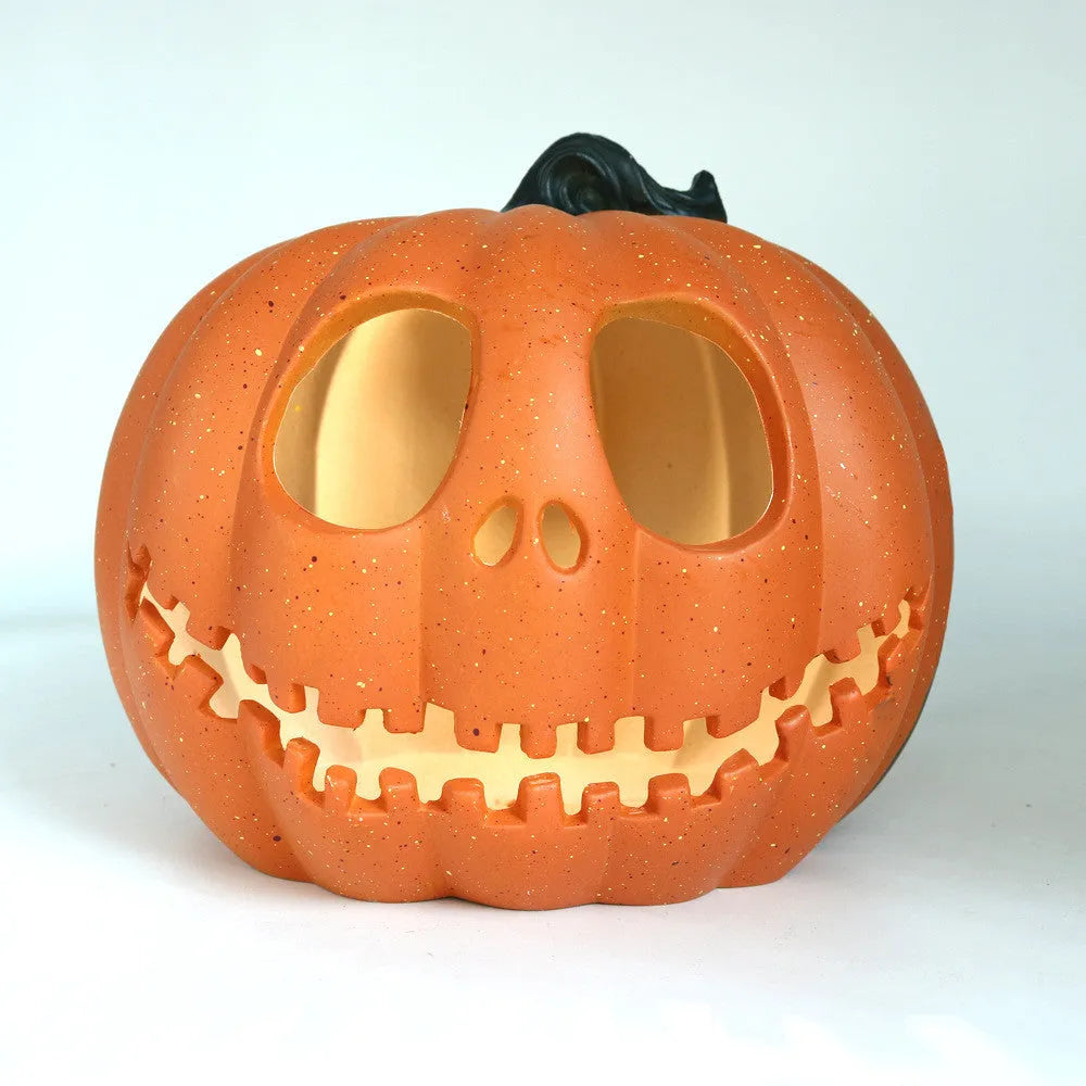 Yellow Halloween pumpkin lantern with hollow-out skull hooded design, resin prop measuring 23 x 19cm