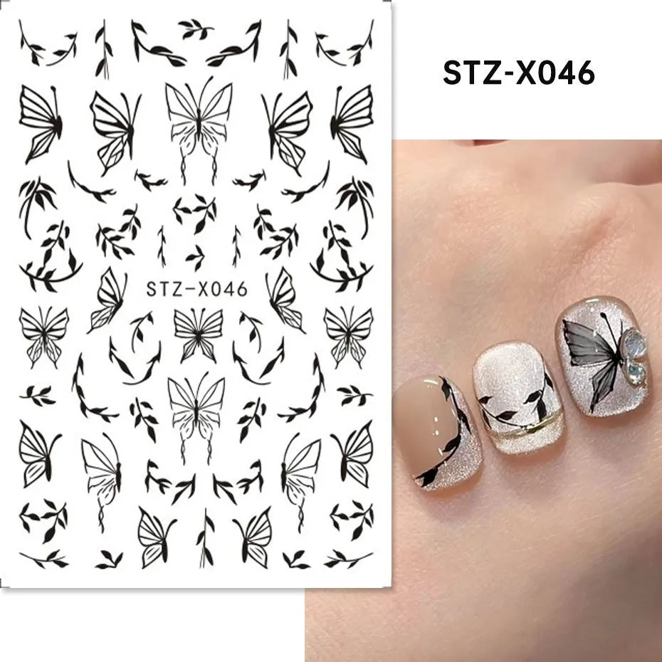 Assortment of black and silver nail sticker designs including cartoon and French tip patterns on a plastic sheet.